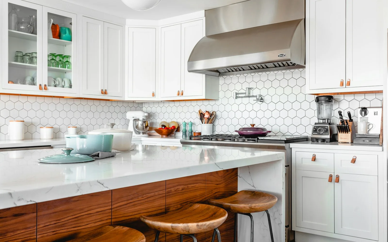 A finished kitchen with white cabinetry and warm wood details