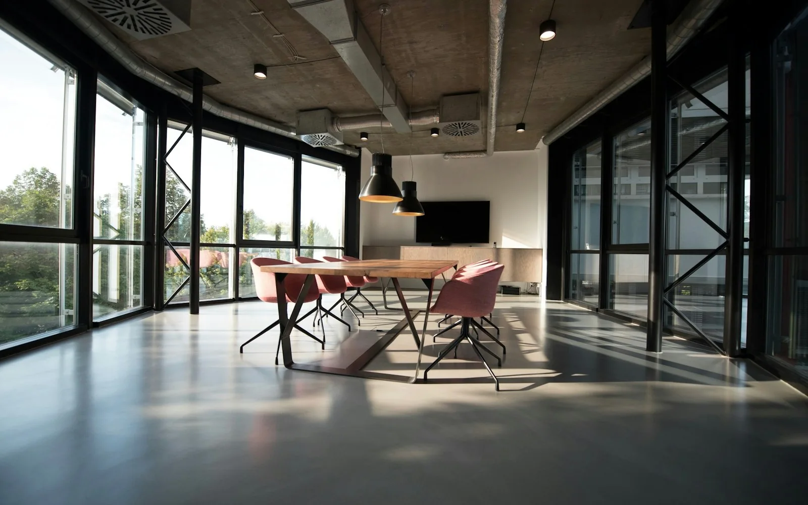 A bright collaborative workspace with natural light and greenery